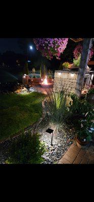 Outdoor kitchen with Fire Pit Patio and outdoor lighting.