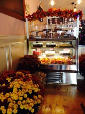 Beautiful, inviting decor displaying cupcakes, cheesecakes and other bakery goods.