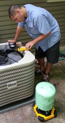 Billy, one of our installers, charging a new air conditioner with refrigerant.