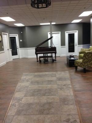 Large rehearsal/recital space equipped with baby grand piano and 60 chairs.