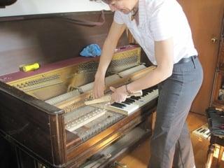 Cleaning underneath the keys in a really dusty piano!