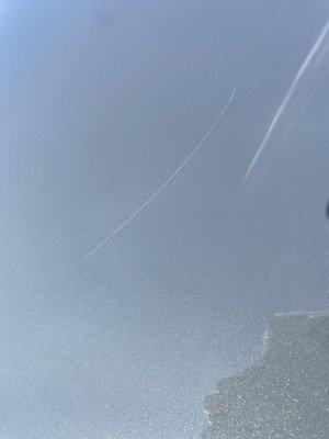 The scratch on the hood of my car caused by Rancho Car Wash