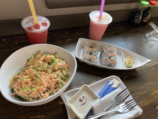 jasmine green tea with strawberries and a strawberry boba tea with a volcano poke bowl, a roll of spicy tuna and a roll of spicy crab.