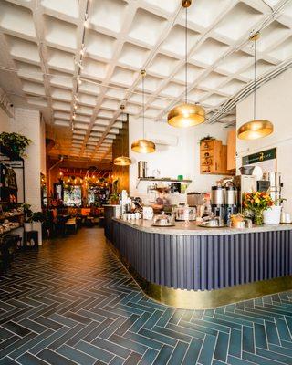 The bar, bright and shiny, with the dining room in the background.