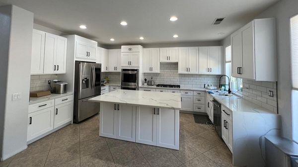 White shaker cabinets with Calacatta White quartz countertops and a full backsplash with 3x6 Flash Subway tile.