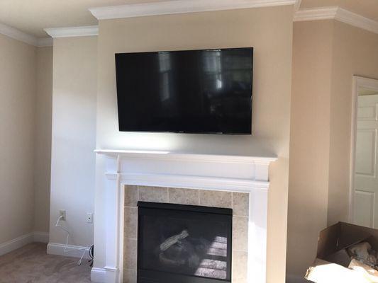 55" TV wall mount above fireplace with power relocation and all component wiring in wall