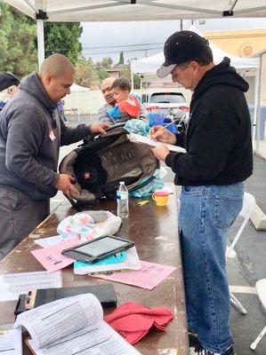 Car seat checkup technicians making sure this child's car seat was in safe conditions during our annual community event!