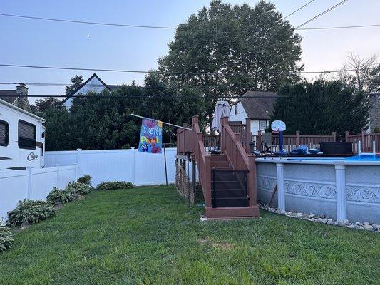 Looking across the back, the rail for the deck is straight. Look at the fence in comparison to the rail.