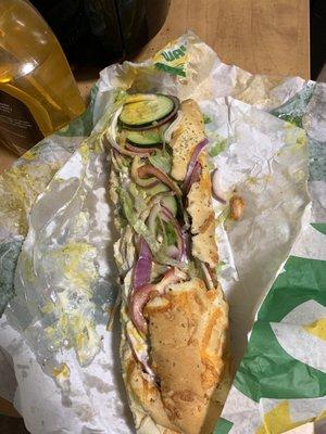 Subway Italian BMT on Italian herb &cheese bread. Lettuce tomato onion cucumber mayo mustard oil and vinegar salt and pepper