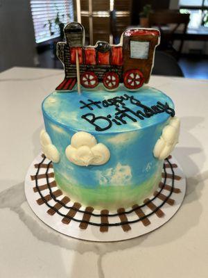 Actual cake with one train cookie.