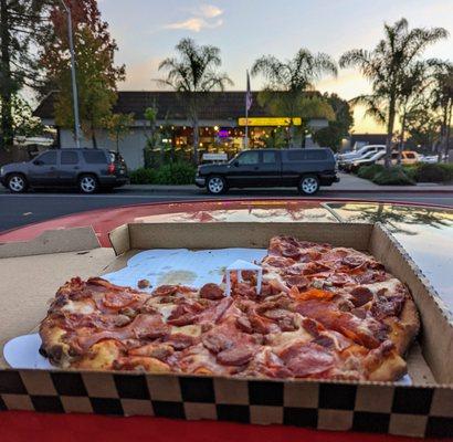 Large all meat, Hector's pizza in the background