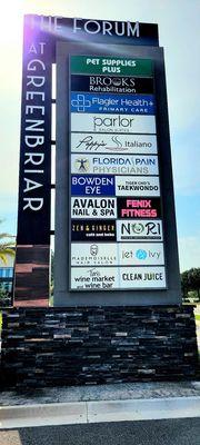 This sign on CR - 210 displays where to turn into the lot of upscale businesses where Florida Pain Physicians is located.