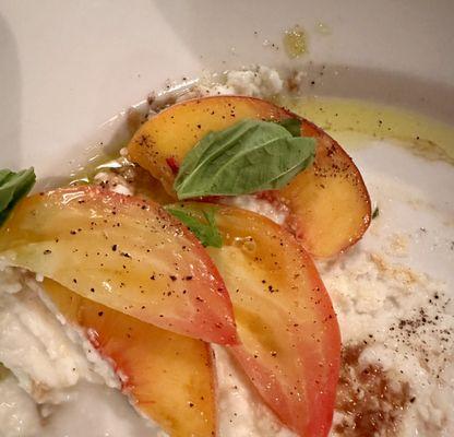 Whipped mozzarella covered by fresh, sliced peaches, and heirloom tomatoes, basil, and delicious olive oil.