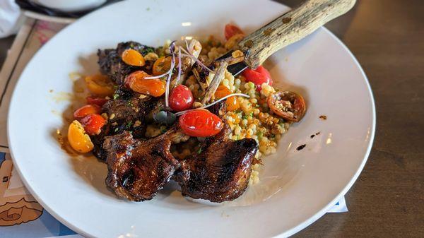 Grilled honey balsamic lamb, herb couscous, charred tomato