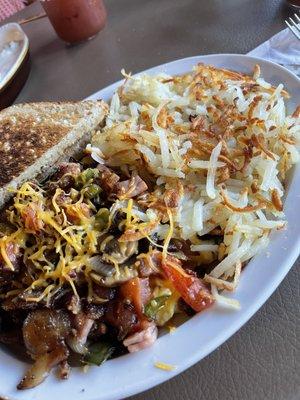 Kitchen Sink Scrambled Eggs and hash browns.