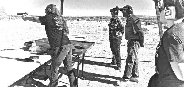 Lisa teaching the class how to stand, breathe, and hold a handgun.