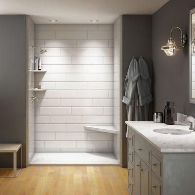 Beautiful walk-in shower with white subway tile finishing and safety bench.