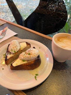 Poached egg on bread- that dollup under the egg, that's butter! And worth it, so good