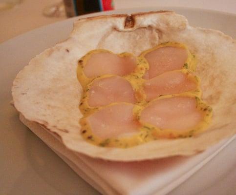 Maine diver scallop, sashimi style with dill mustard, after being presented with the live scallop in-shell