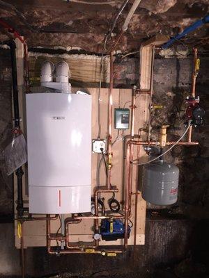 Combination boiler with on demand hot water installation