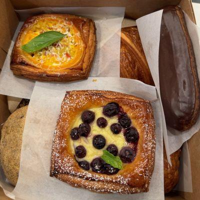 From the top: Tomato Savory Danish, Pain Au Chocolat, Classic Eclair, Snickerdoodle, Fruit and Custard Danish