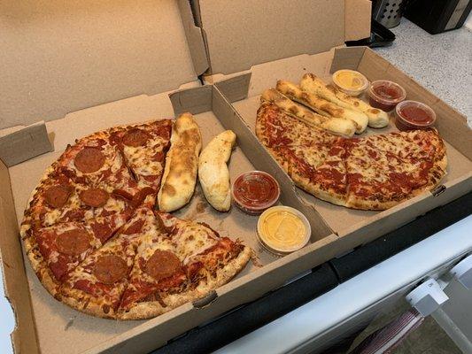 Pepperoni pizza, cheese pizza, and breadsticks. We get our pizzas with light cheese. Some of its already eaten, of course.