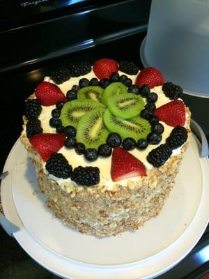 Angel Food Fruit Cake. Angel food cake, light whipped frosting, fresh fruit.