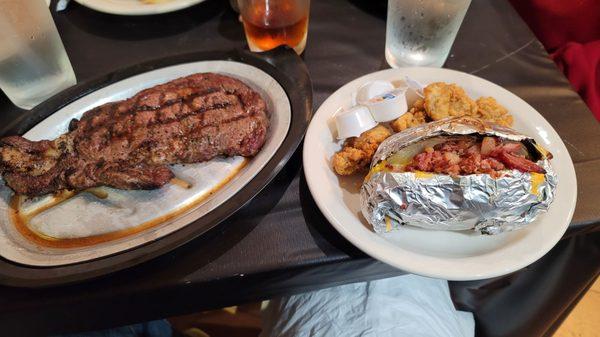 Surf and turf: A perfect ribeye with oysters and a loaded baked potato.