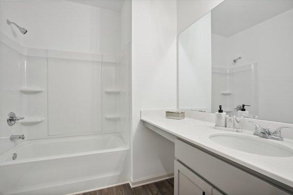 Secondary bathroom with garden tub shower.