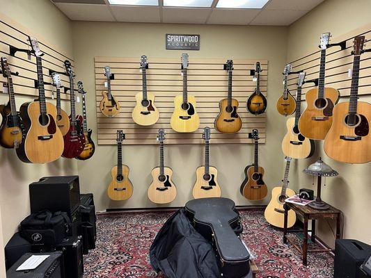 This is a photo of acoustic and electric guitars as well as mandolins.