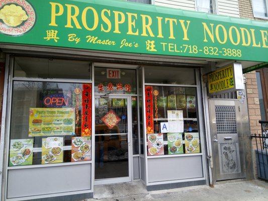 Exterior of Prosperity Noodle (A food Grade in the window).