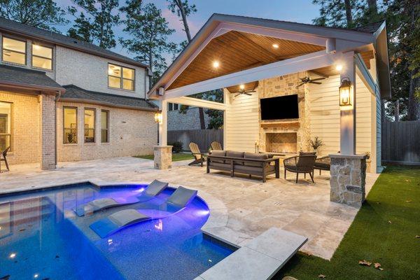 Freestanding pool house with a fireplace