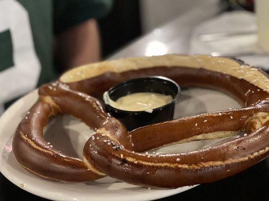 Giant warm pretzel with cheese sauce