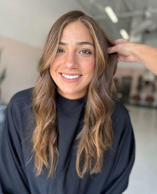 Check out the well placed face framing. Balayage allows us to highlight just so. Her smile says it all.