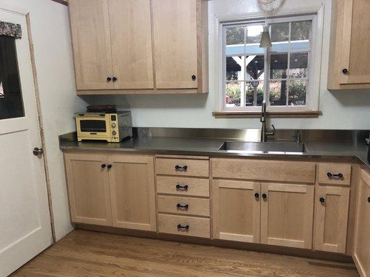 Integrated stainless steel sink, counter & backsplash... looks good and is super functional!