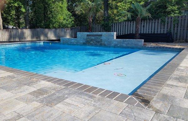 Allow the children a place to play by adding a sun ledge to your new concrete pool.