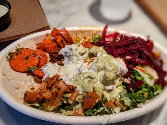 My brisket, chicken, and hummus bowl topped with tahini and house sauce.