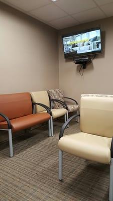 The waiting room. Several people are here and it's pretty quiet. Normal noises though. Nothing too loud and annoying.