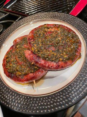 Ring pork sausage with their chimichurri on top. Yum!