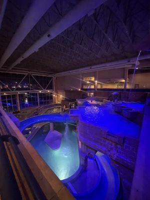 Night shot of indoor pool and water slide