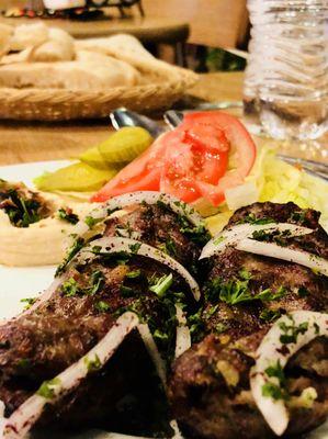 kebab plate with salad and hummus