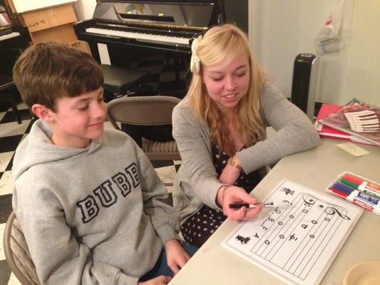 Louise, one of our piano instructors, explaining a theory concept to her piano student.