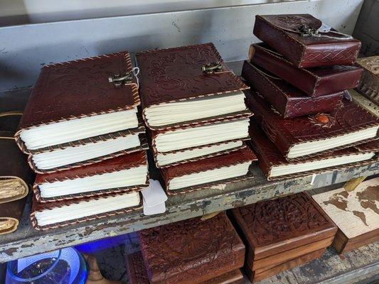 Leather journals and carved wooden boxes.