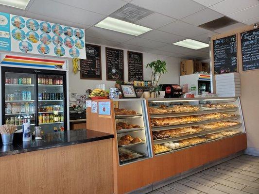 Main counter filled with fresh donuts and pastries.