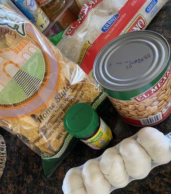 Home style tortilla chips, pinto beans, rice, garlic and chicken bouillon. Carne asada is in the fridge :).