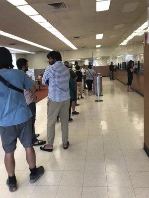 Long line, middle of the day. Only two tellers.