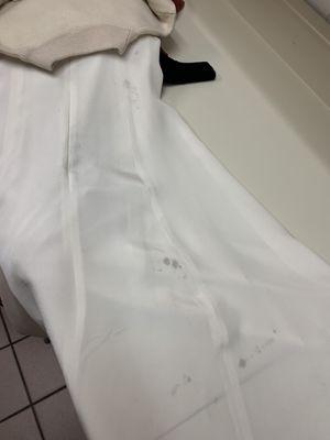 Silk dress with black stains from dry cleaning