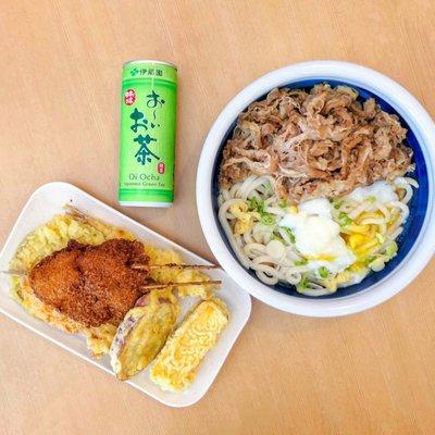 A variety of freshly fried Tempura, green tea, and a large Nikutama Udon