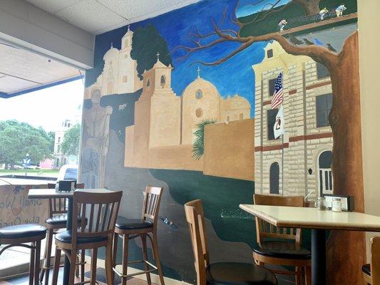 Restaurant interior: mural of historic sites Goliad.