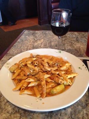 Blackened chicken (from dinner menu) with extra artichokes and a glass of Merlot.